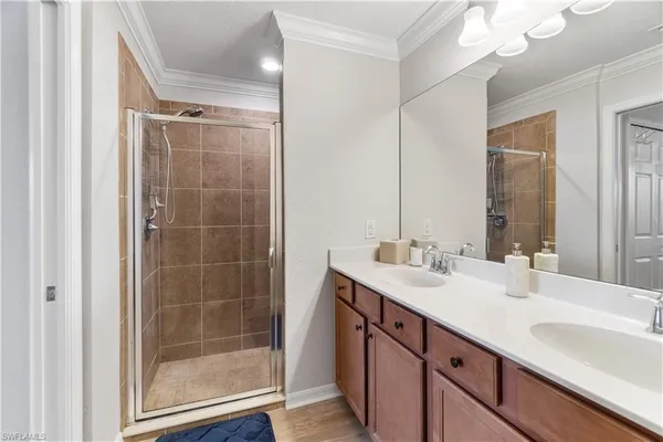 a bathroom with a shower sink vanity granite and mirror
