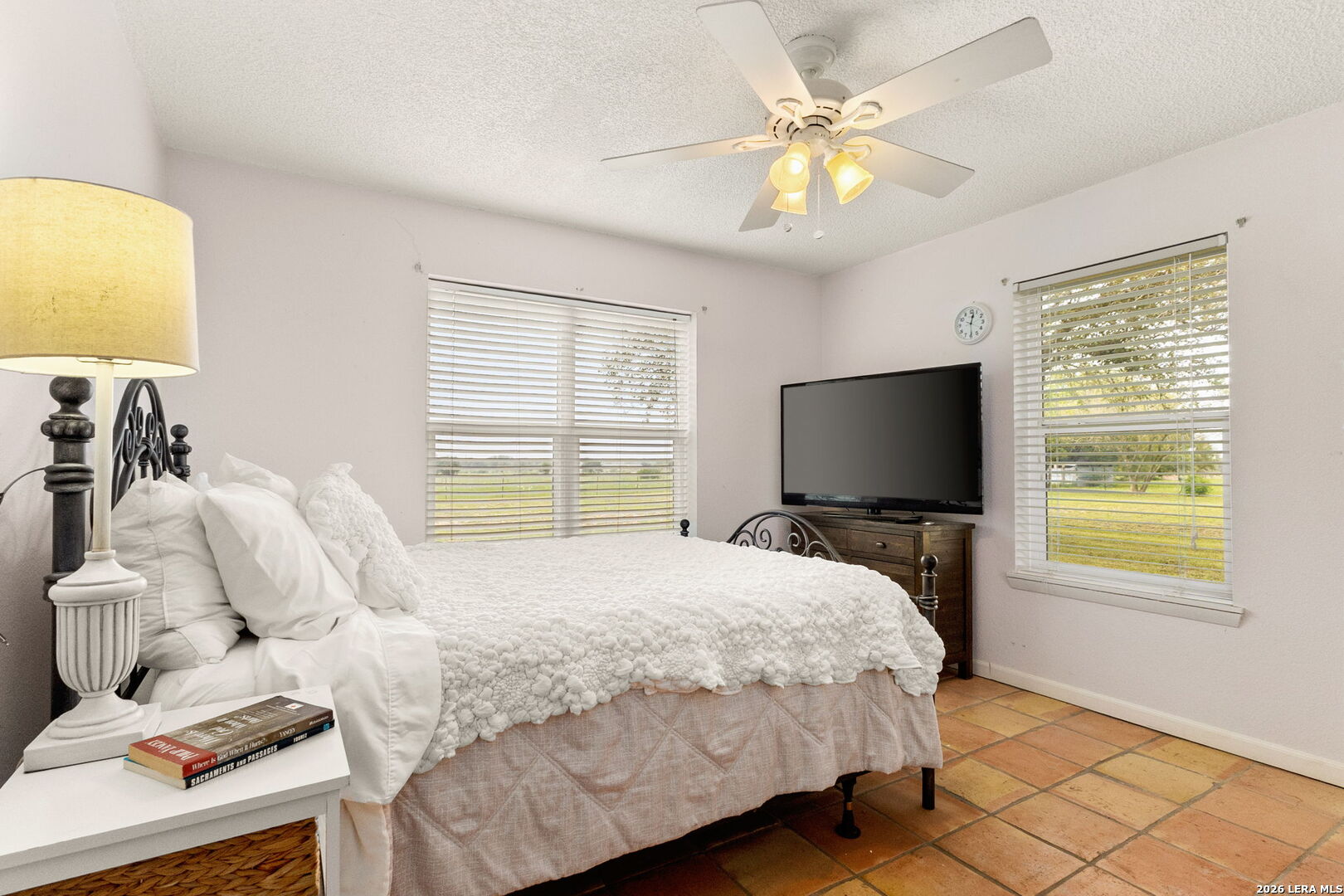 350 Ullrich Road Marion, TX 78124 - Photo 22 of 43 a bedroom with a bed and a chandelier
