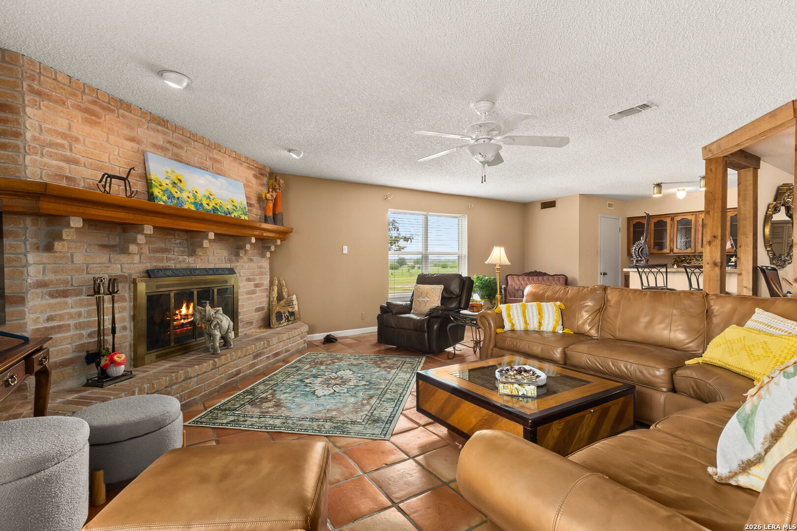 350 Ullrich Road Marion, TX 78124 - Photo 4 of 43 a living room with furniture a fireplace and a ceiling fan
