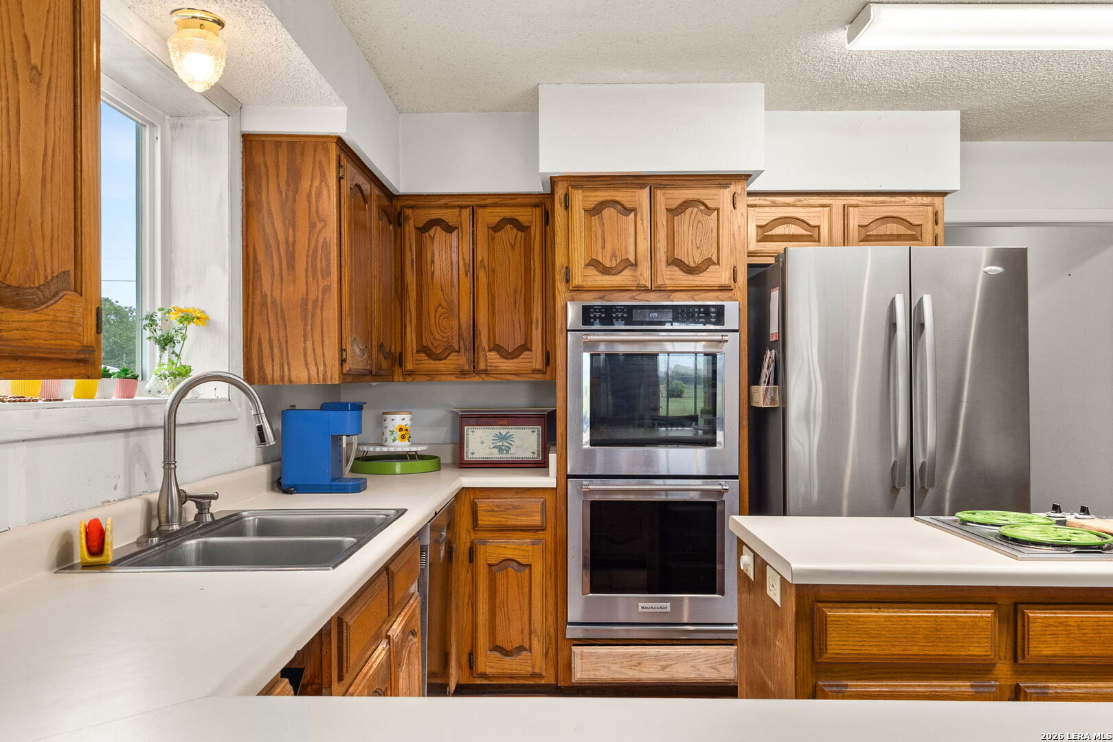 350 Ullrich Road Marion, TX 78124 - Photo 8 of 43 a kitchen with stainless steel appliances granite countertop a sink and a refrigerator
