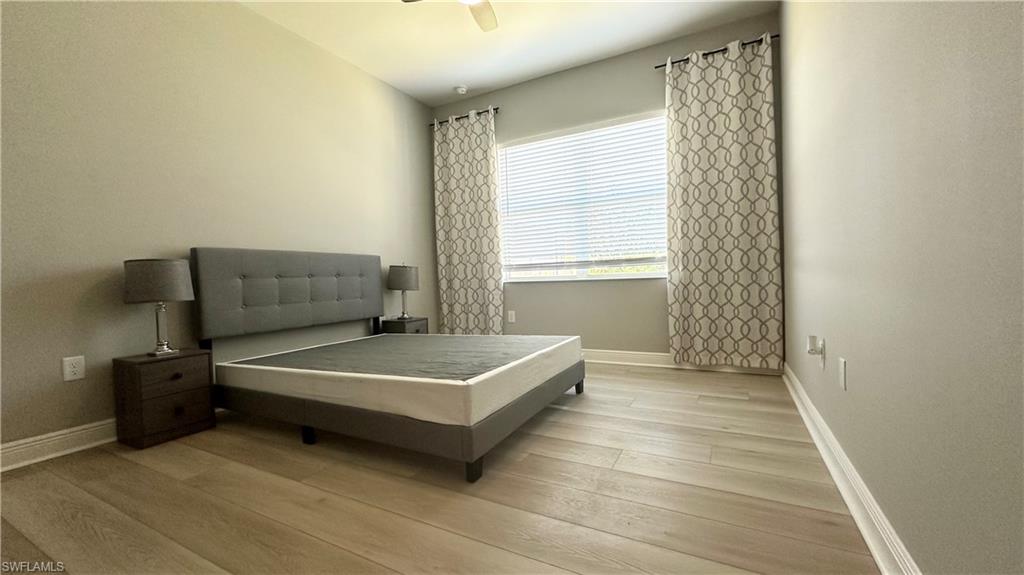 3998 Perseus Street Naples, FL 34120 - Photo 12 of 26 Bedroom featuring light wood-type flooring and a ceiling fan