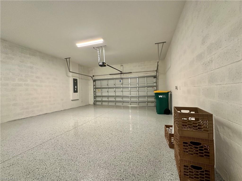 3998 Perseus Street Naples, FL 34120 - Photo 15 of 26 Garage with concrete block wall and electric panel