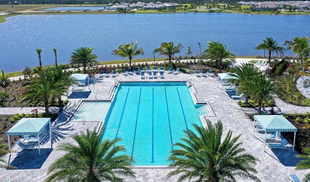 3998 Perseus Street Naples, FL 34120 - Photo 21 of 26 Community pool featuring a water view and a patio area