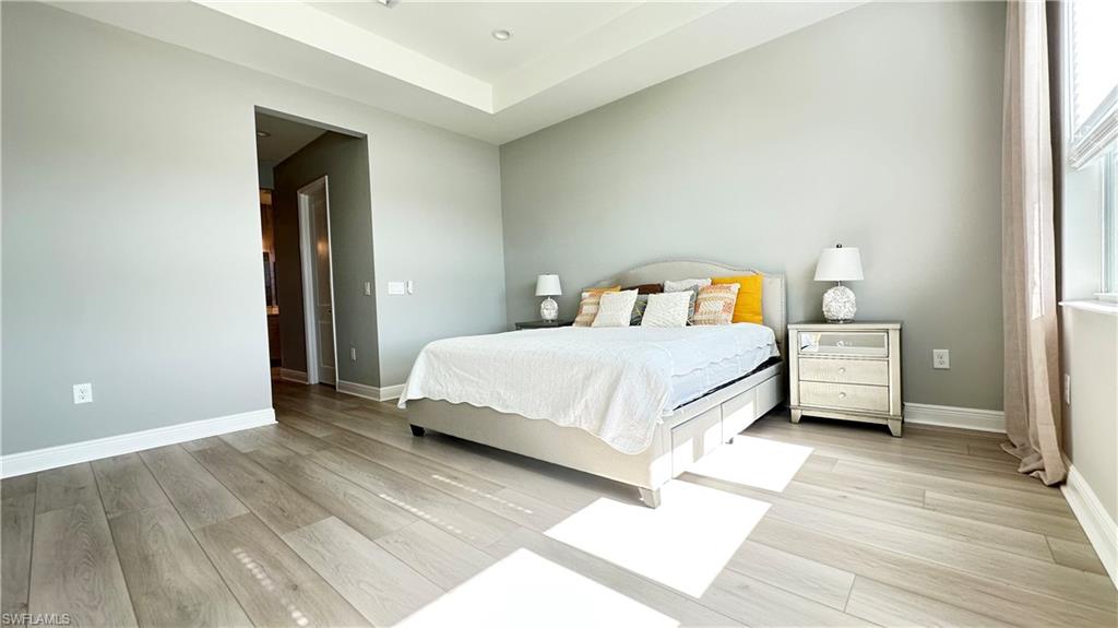 3998 Perseus Street Naples, FL 34120 - Photo 7 of 26 Bedroom with light wood finished floors and baseboards