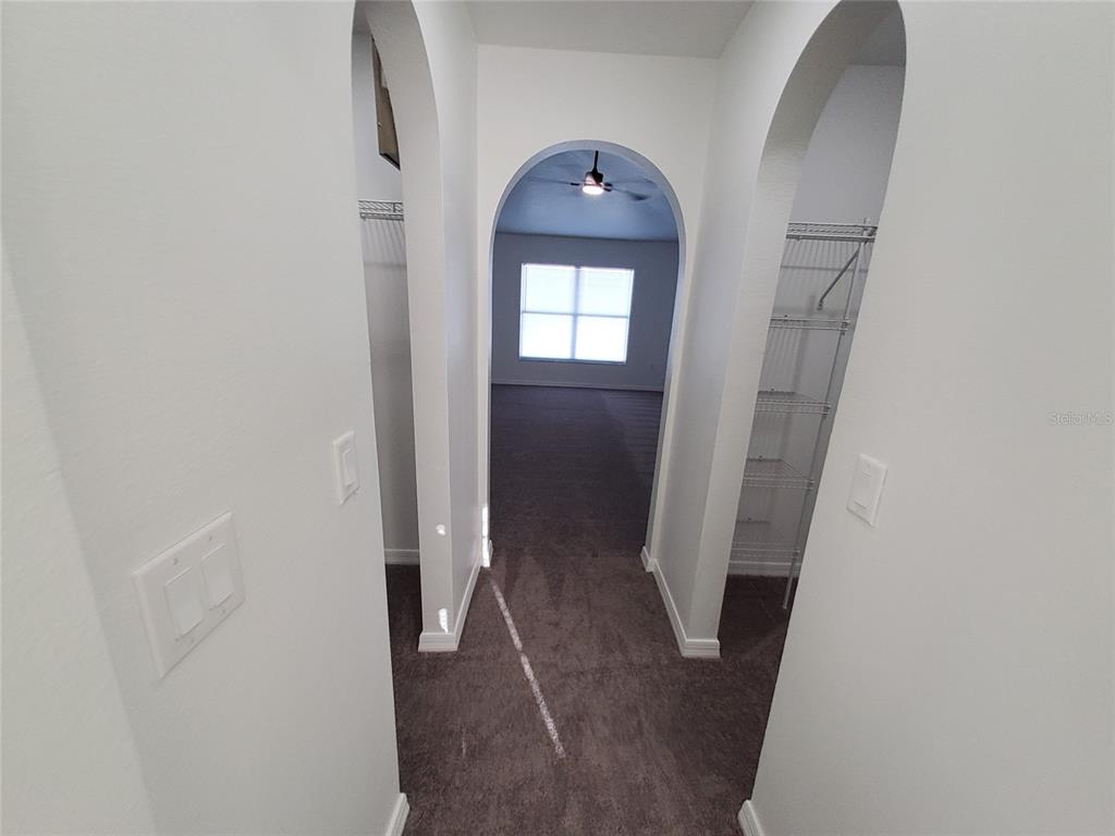 509 Ridges Drive Dundee, FL 33838 - Photo 17 of 33 a view of a hallway with wooden floor and a bathroom