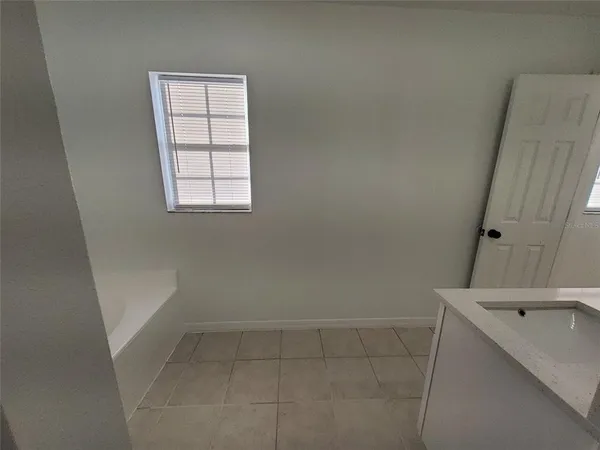 a bathroom with a double vanity sink a toilet and a mirror