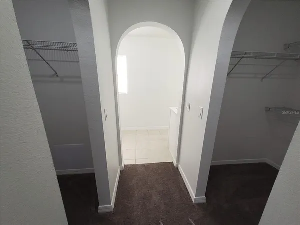 a bathroom with a shower a toilet and a window