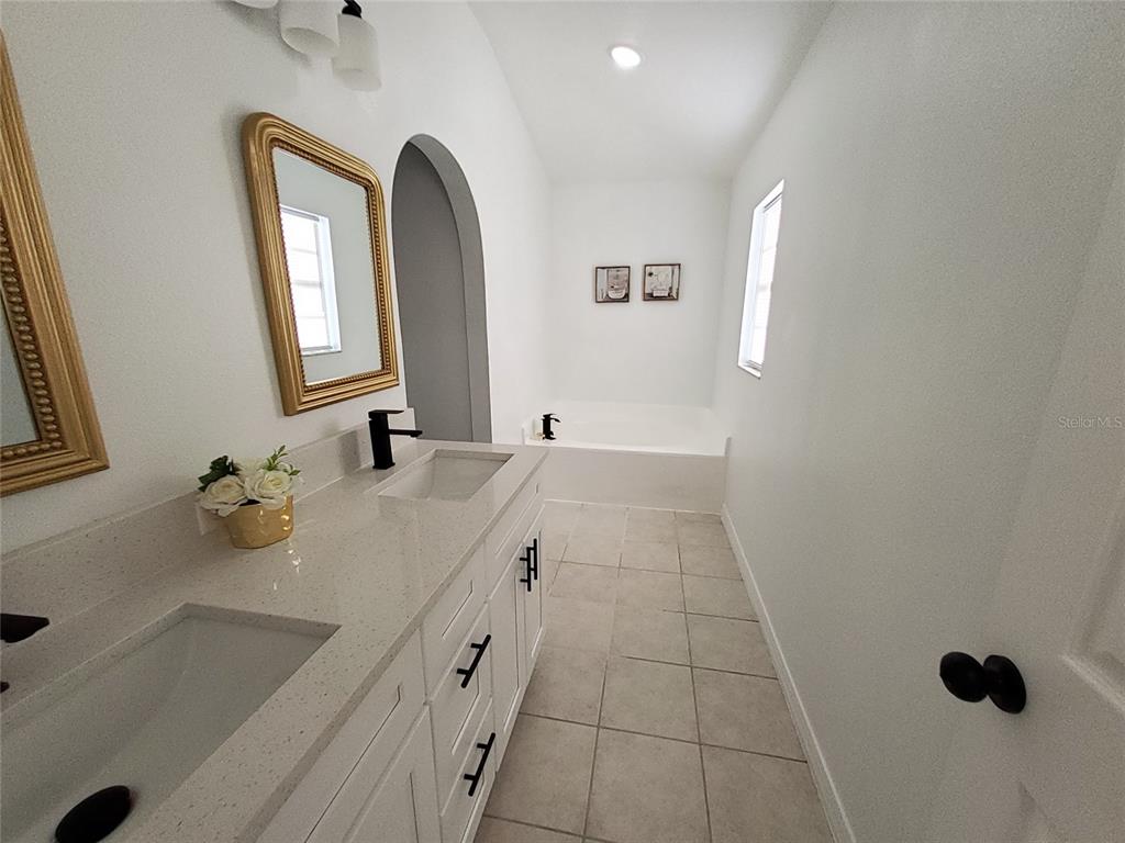 509 Ridges Drive Dundee, FL 33838 - Photo 20 of 33 a bathroom with a double vanity sink a toilet and a mirror