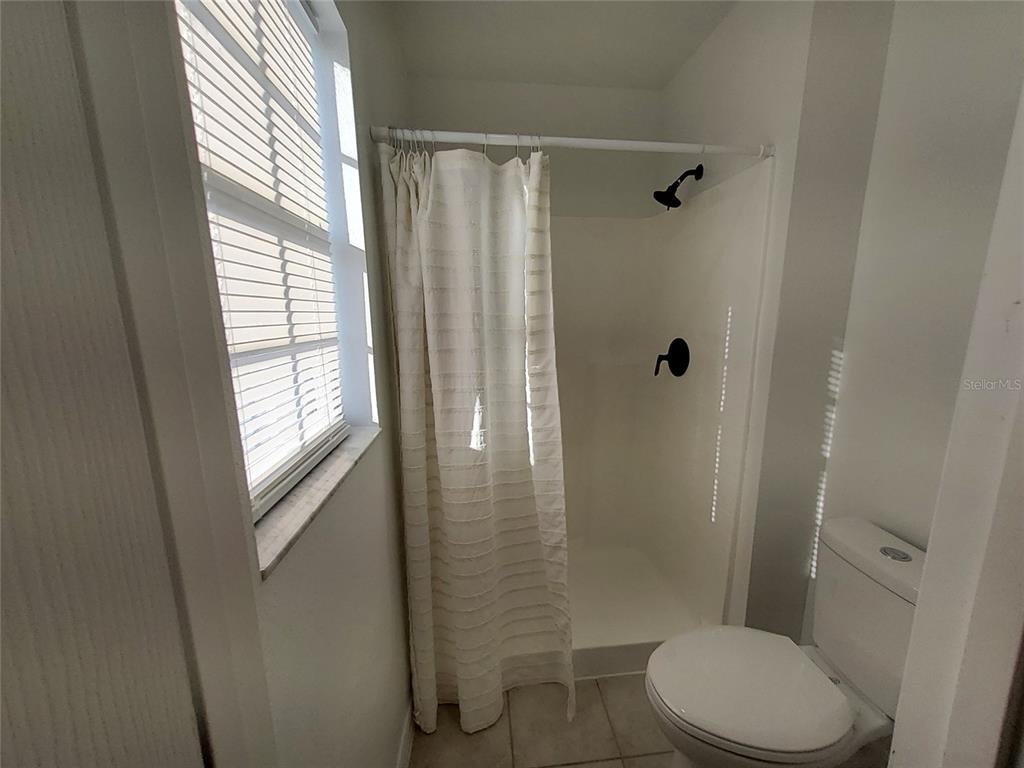 509 Ridges Drive Dundee, FL 33838 - Photo 21 of 33 a bathroom with a shower a toilet and a window