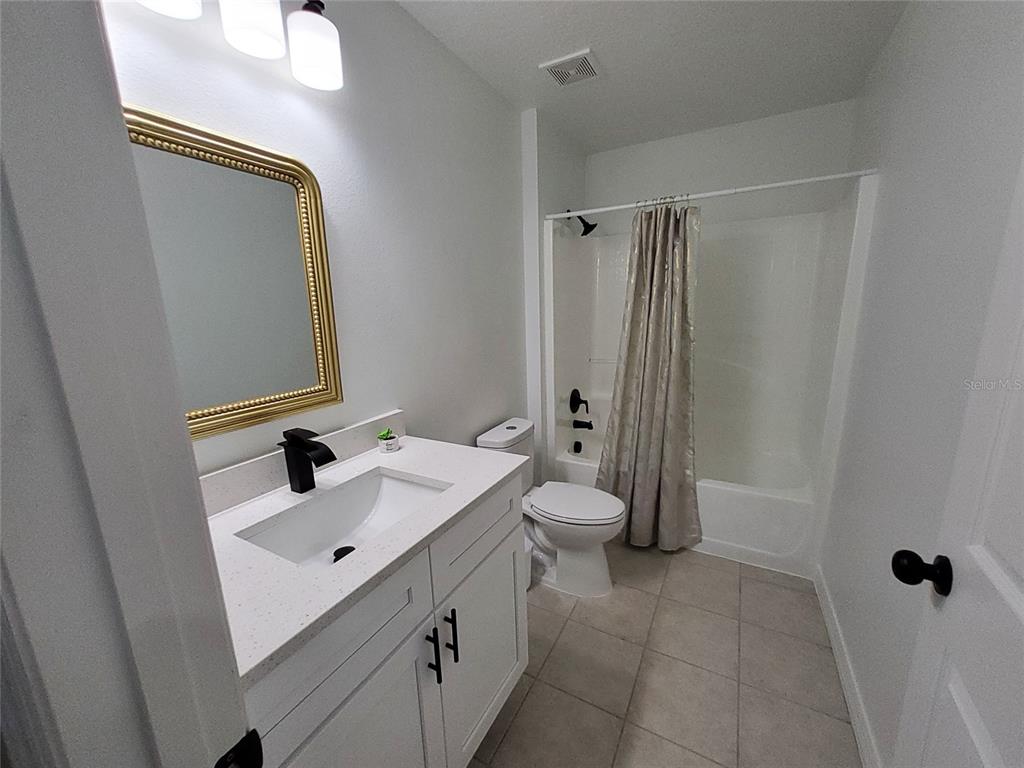 509 Ridges Drive Dundee, FL 33838 - Photo 24 of 33 a bathroom with a sink a toilet and shower