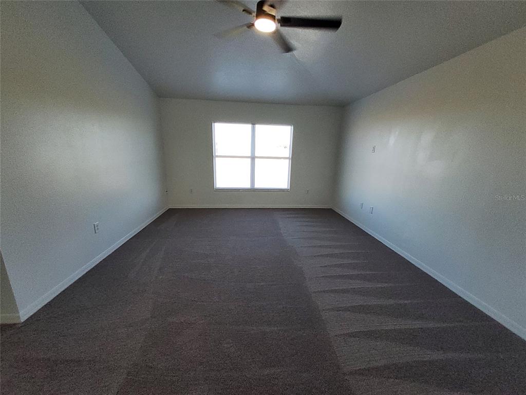 509 Ridges Drive Dundee, FL 33838 - Photo 25 of 33 en empty room with windows and ceiling fan