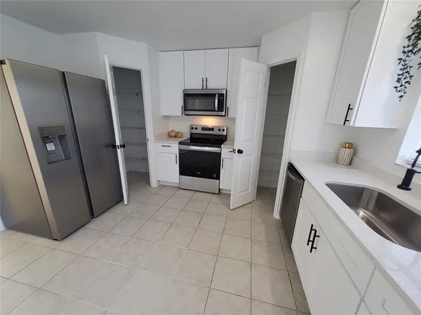 a kitchen with a refrigerator sink and microwave