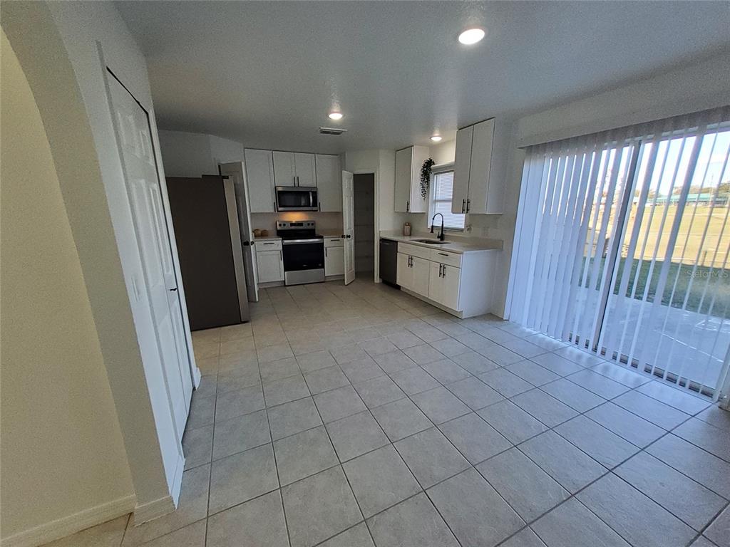 509 Ridges Drive Dundee, FL 33838 - Photo 6 of 33 a kitchen with stainless steel appliances a refrigerator and a sink