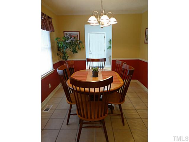 432 Langdon Road Angier, NC 27501 - Photo 8 of 23 a view of a dining room with furniture and a chandelier