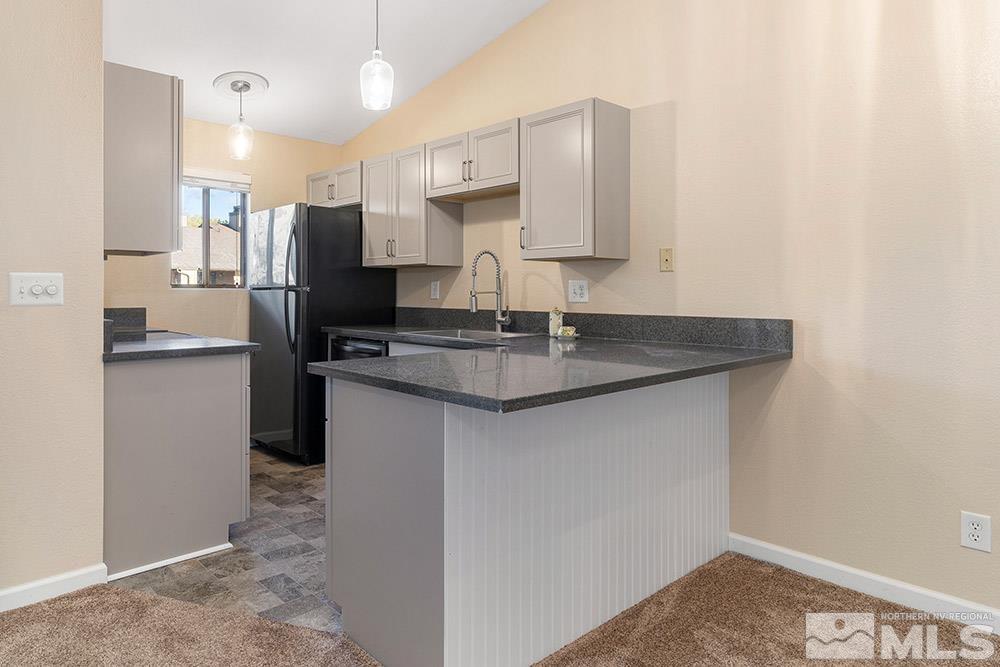 4386 Matich Drive Reno, NV 89502 - Photo 6 of 20 a kitchen with stainless steel appliances granite countertop a sink stove and refrigerator