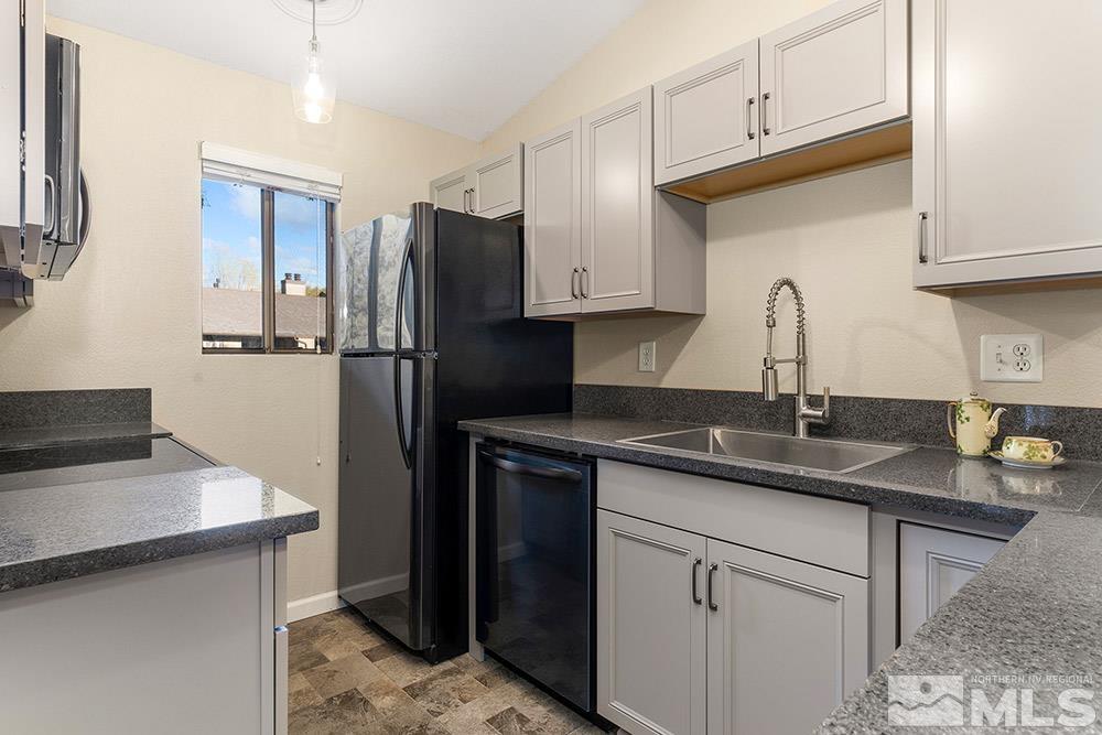 4386 Matich Drive Reno, NV 89502 - Photo 8 of 20 a kitchen with granite countertop a sink stove and refrigerator