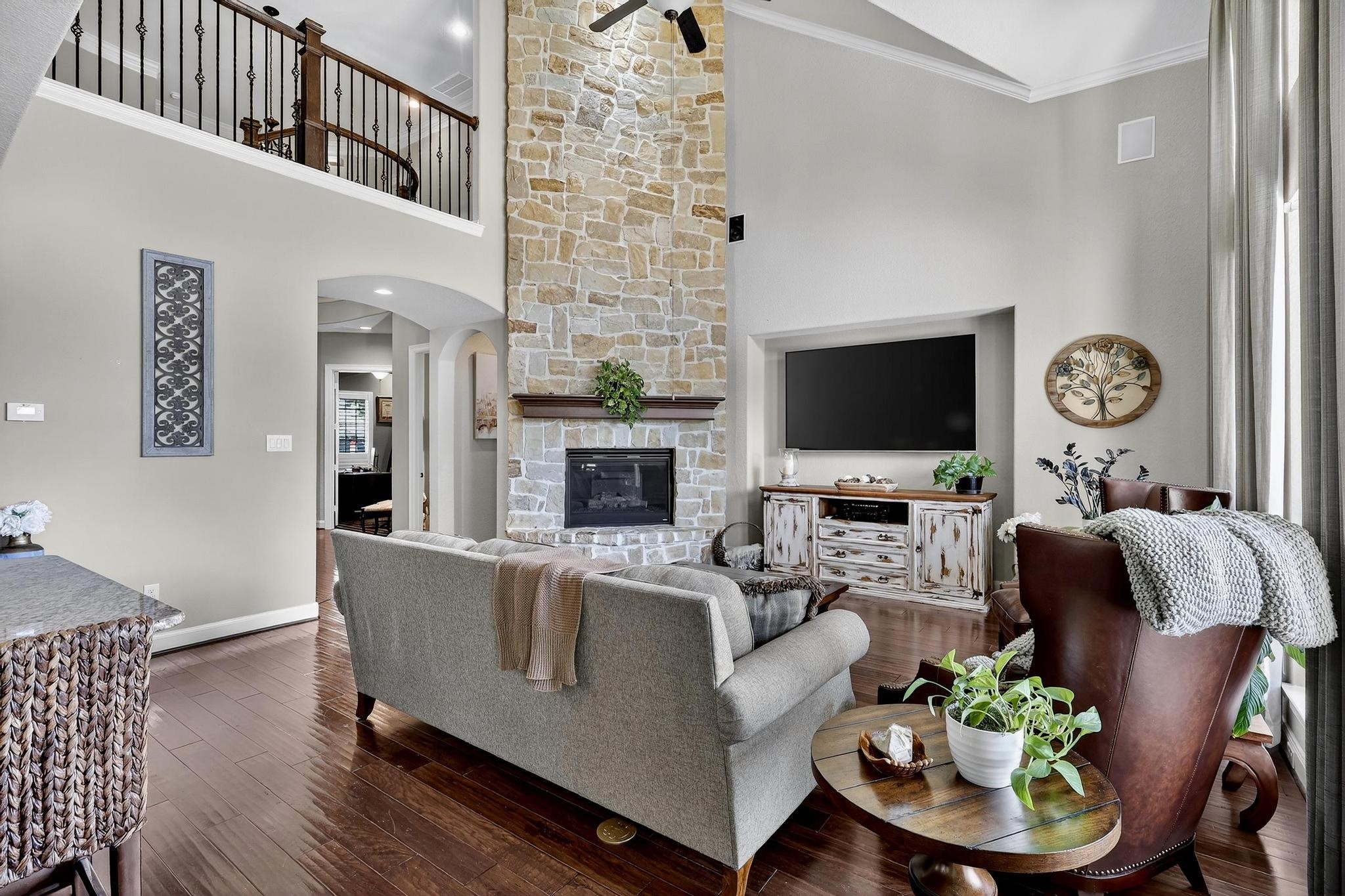 25803 Heritage Maple Drive Spring, TX 77389 - Photo 13 of 46 a living room with furniture a fireplace and a flat screen tv