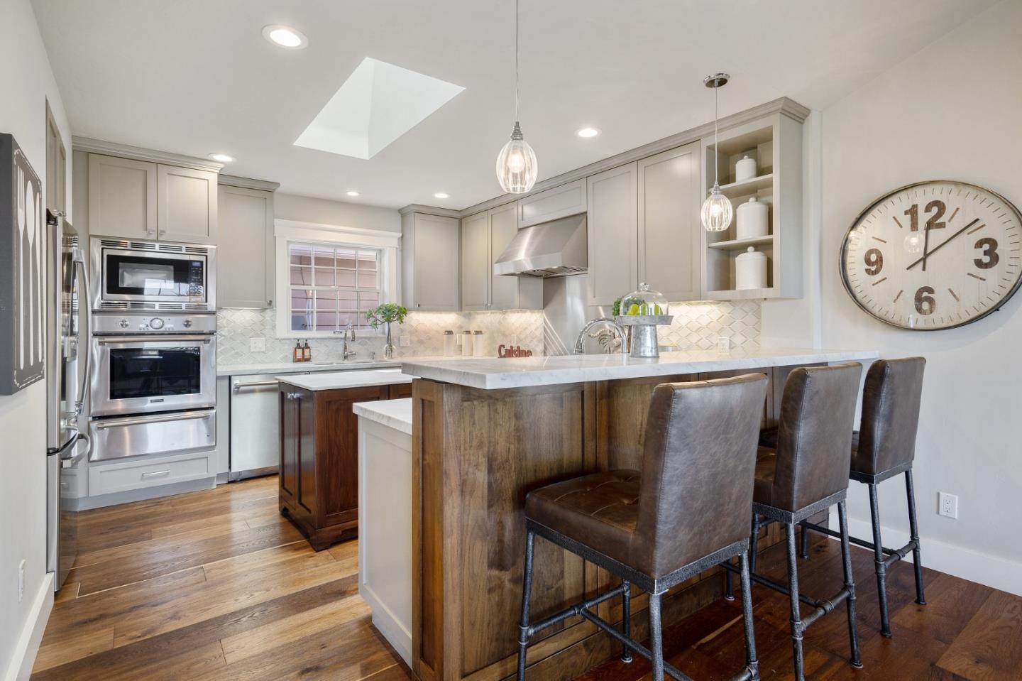 910 Sunset Drive San Carlos, CA 94070 - Photo 16 of 62 a kitchen with a dining table chairs and refrigerator