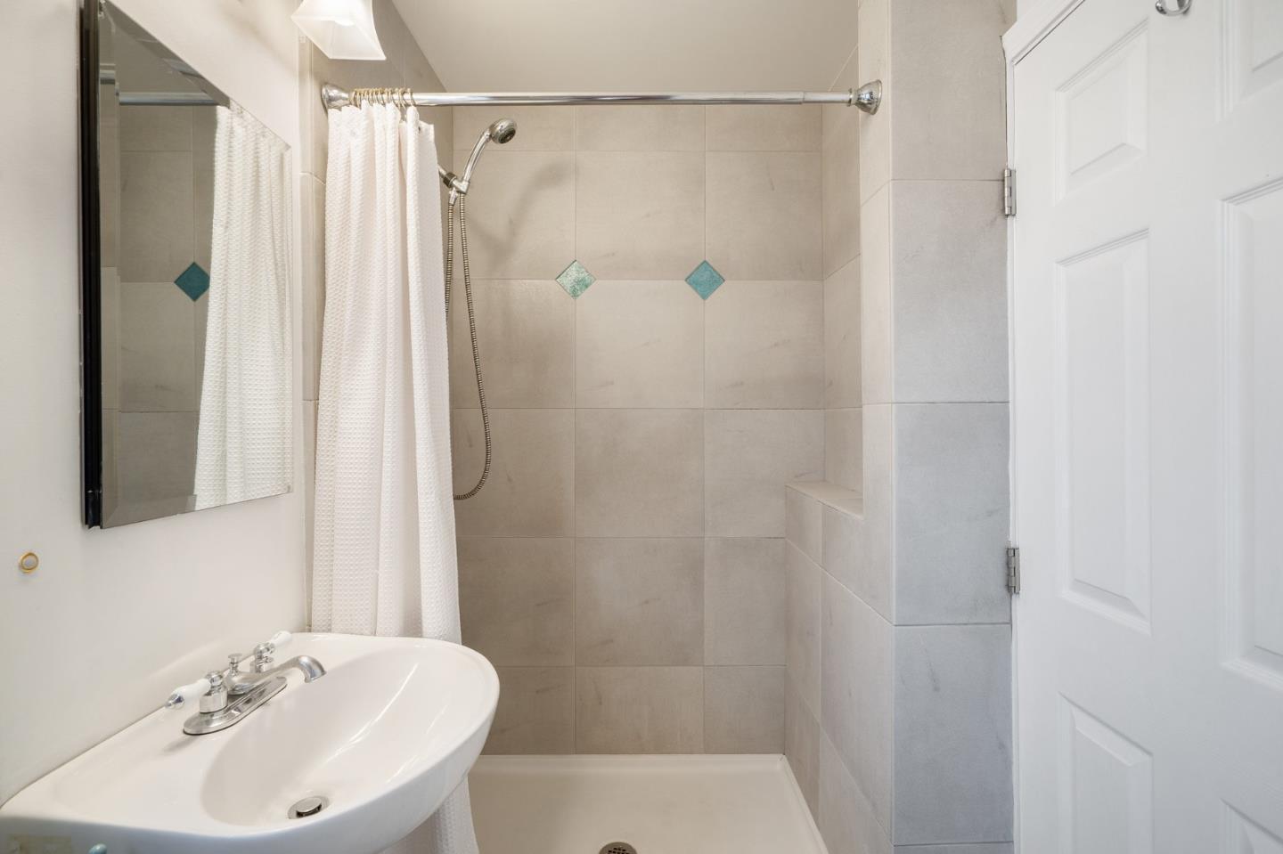 910 Sunset Drive San Carlos, CA 94070 - Photo 52 of 62 a bathroom with a sink shower and a mirror