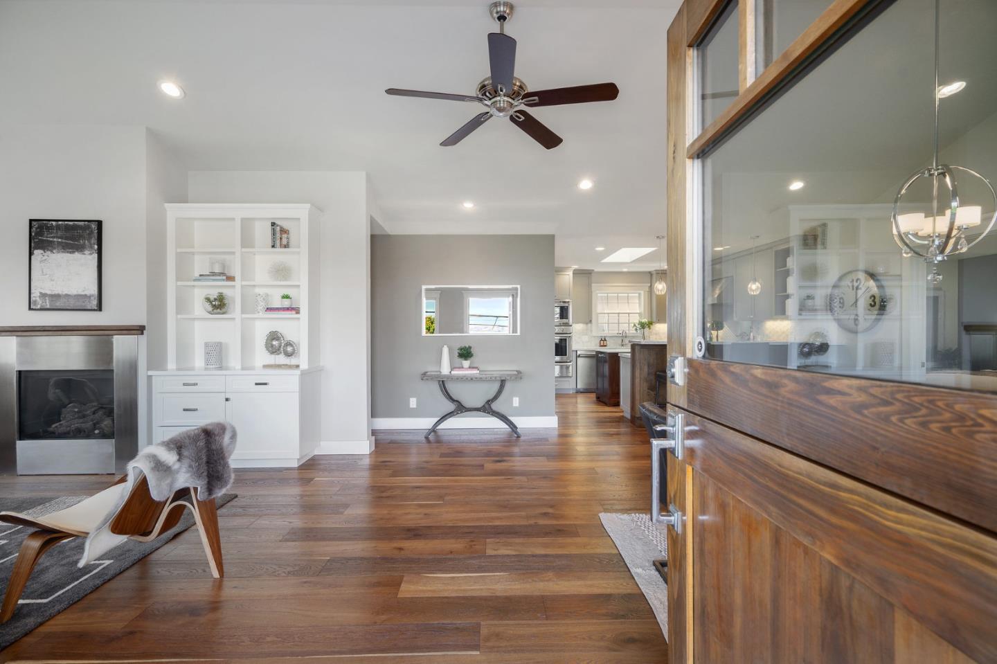 910 Sunset Drive San Carlos, CA 94070 - Photo 7 of 62 a living room with furniture a fireplace and a chandelier