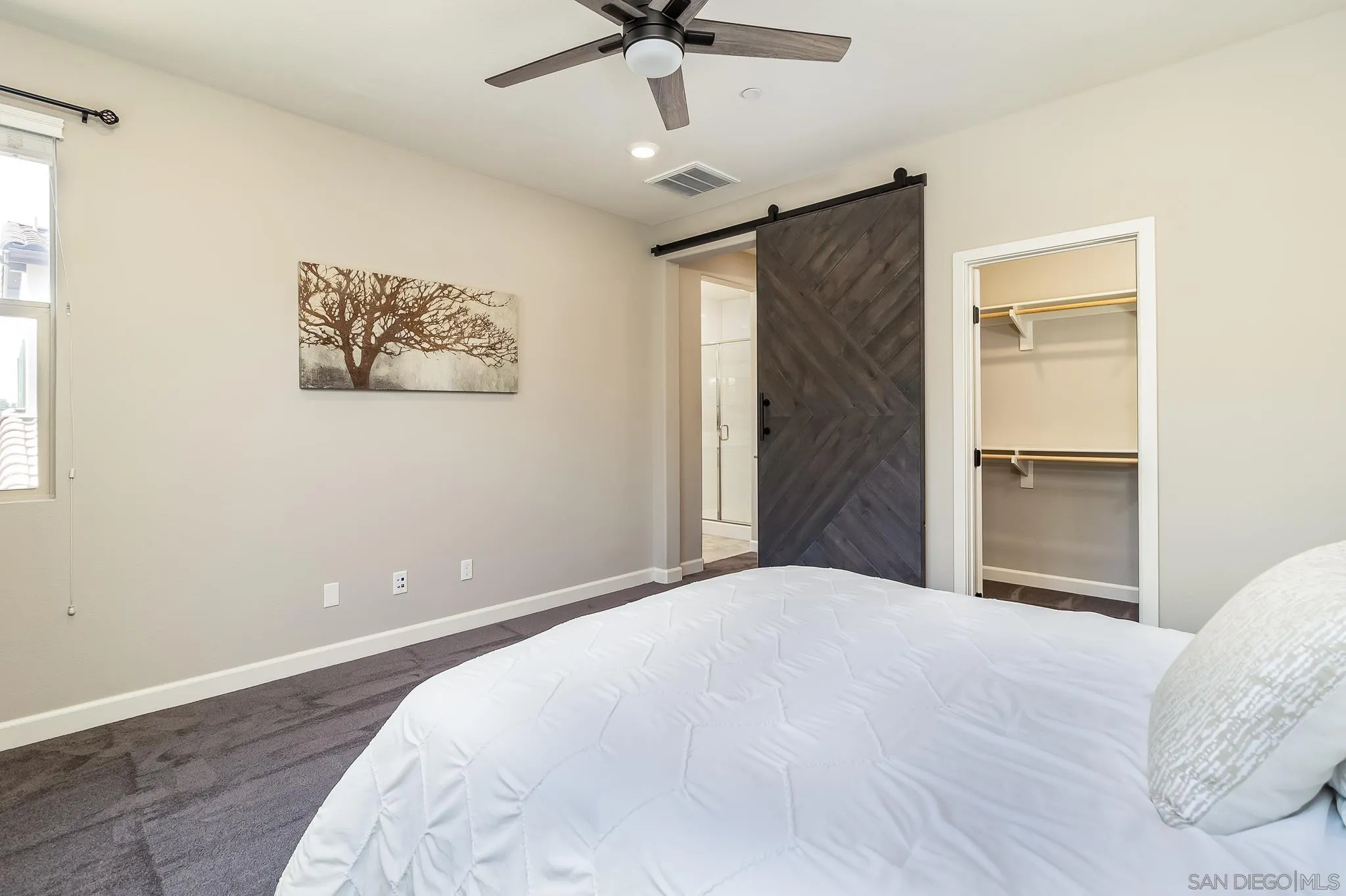 1094 Delpy View Point Vista, CA 92084 - Photo 15 of 43 a bedroom with a bed and a ceiling fan