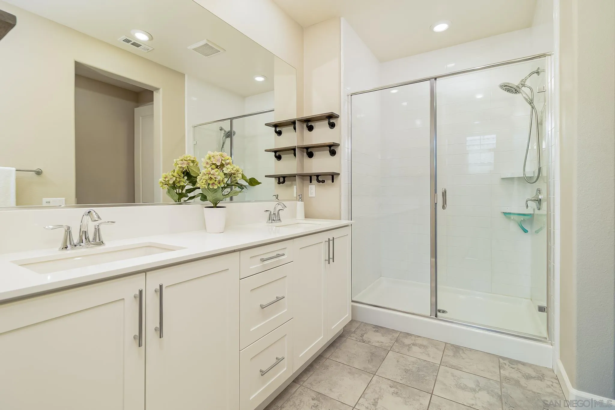 1094 Delpy View Point Vista, CA 92084 - Photo 17 of 43 a bathroom with a double vanity sink mirror and shower