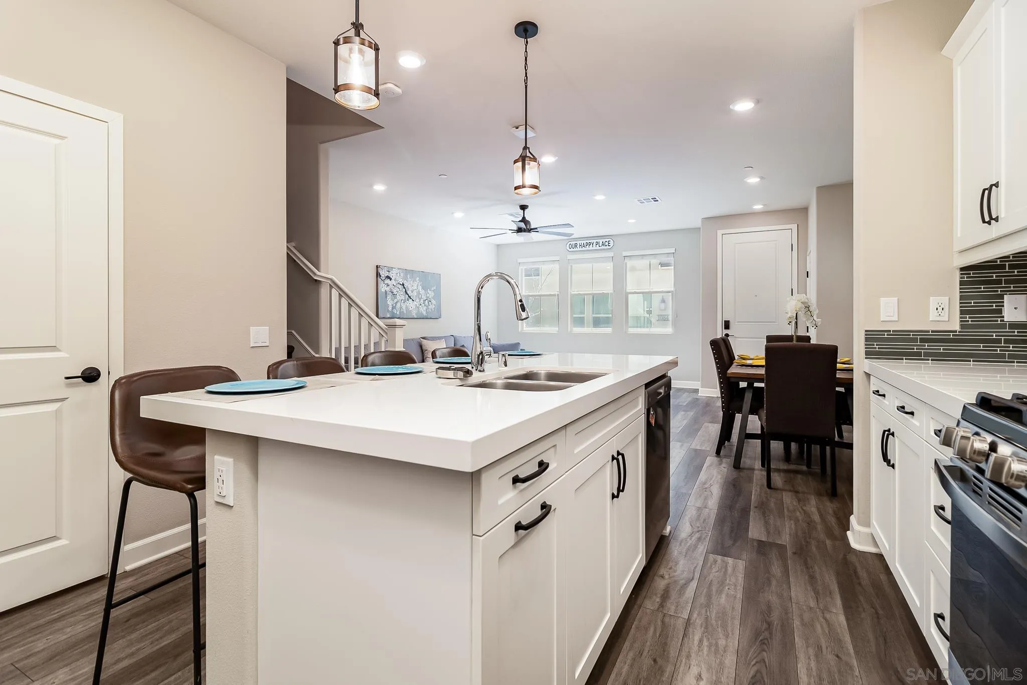 1094 Delpy View Point Vista, CA 92084 - Photo 7 of 43 a kitchen with kitchen island a sink dining table and chairs