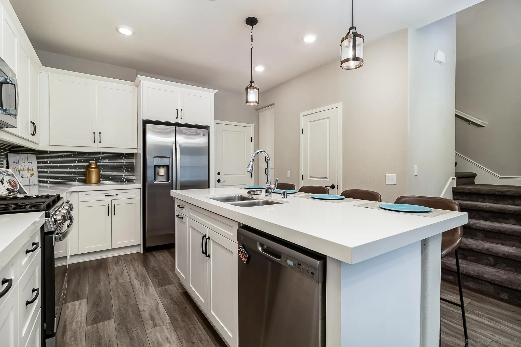 1094 Delpy View Point Vista, CA 92084 - Photo 8 of 43 a kitchen with kitchen island a sink appliances and cabinets
