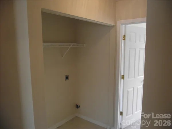 a small space with wooden floor and a window