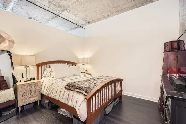 a bedroom with a bed and a night stand