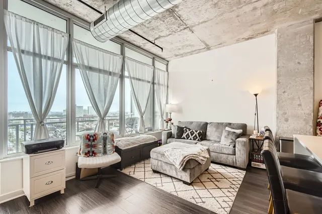a living room with furniture and a floor to ceiling window