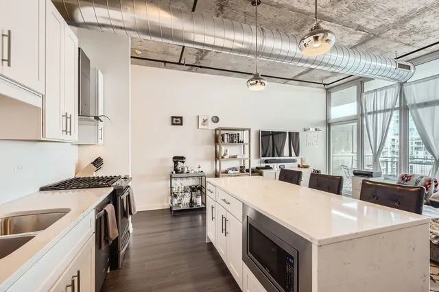 a kitchen with a stove a sink and a refrigerator