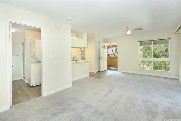 an empty room with windows and closet