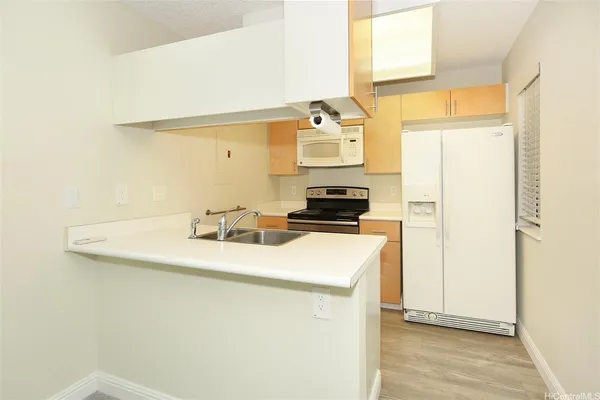 a kitchen with a sink a stove and a refrigerator