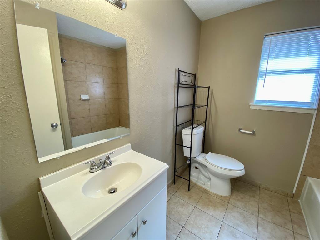 7004 Bennington Drive Watauga, TX 76148 - Photo 13 of 16 a bathroom with a sink toilet and shower