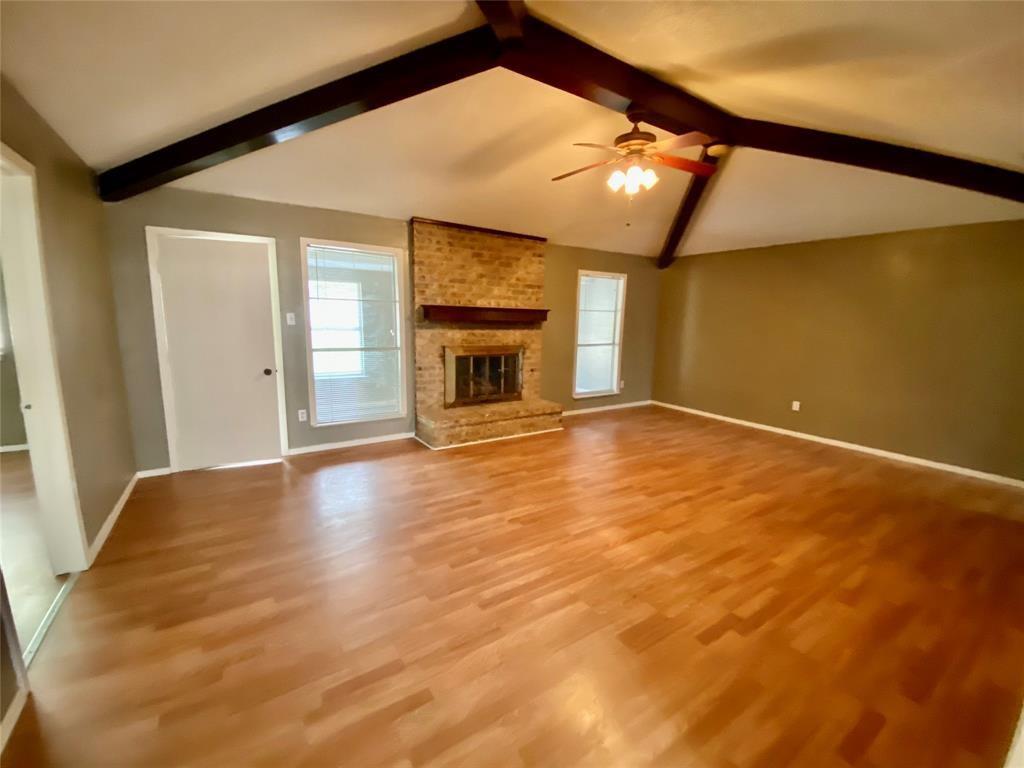 7004 Bennington Drive Watauga, TX 76148 - Photo 6 of 16 a view of an empty room with wooden floor and a window