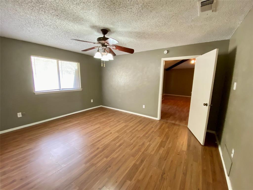 7004 Bennington Drive Watauga, TX 76148 - Photo 9 of 16 wooden floor in an empty room with a window