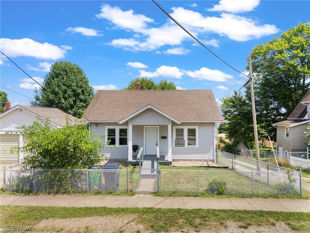 16 South State Street Rittman, OH 44270 - Photo 1 of 27 Bungalow with a chimney, roof with shingles, and a fenced front yard