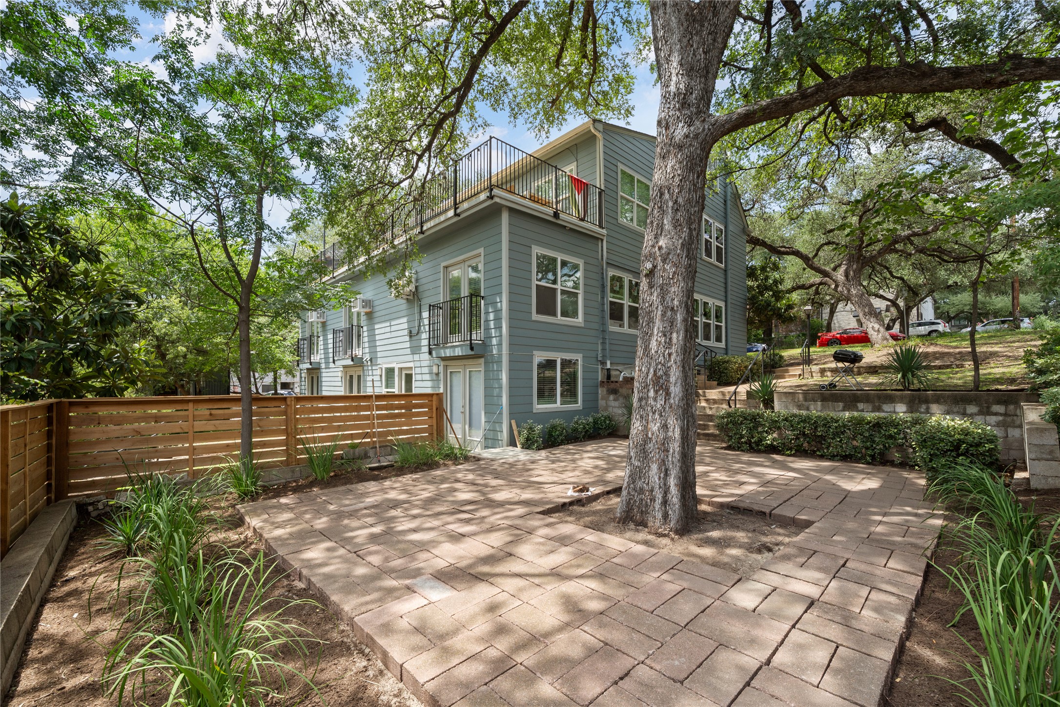 201 West 31st Street, Unit E Austin, TX 78705 - Photo 1 of 16 A private fenced yard with paver patio, perfect for entertaining or relaxing outdoors.