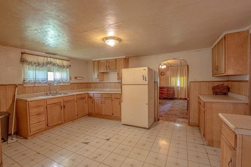 810 Pleasant View Smock Road Smock, PA 15480 - Photo 3 of 12 a kitchen with a refrigerator a sink and dishwasher