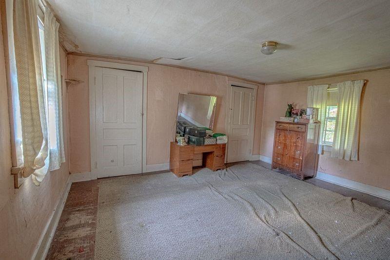 810 Pleasant View Smock Road Smock, PA 15480 - Photo 4 of 12 an empty room with windows and closet