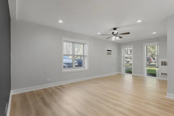 wooden floor in an empty room with a window