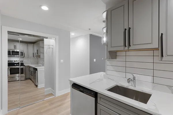 a kitchen with a sink and a refrigerator