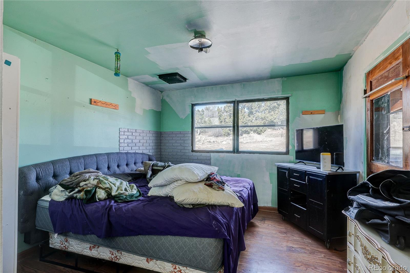 952 Twin Lakes Road Walsenburg, CO 81089 - Photo 20 of 47 a bedroom with a bed and a window