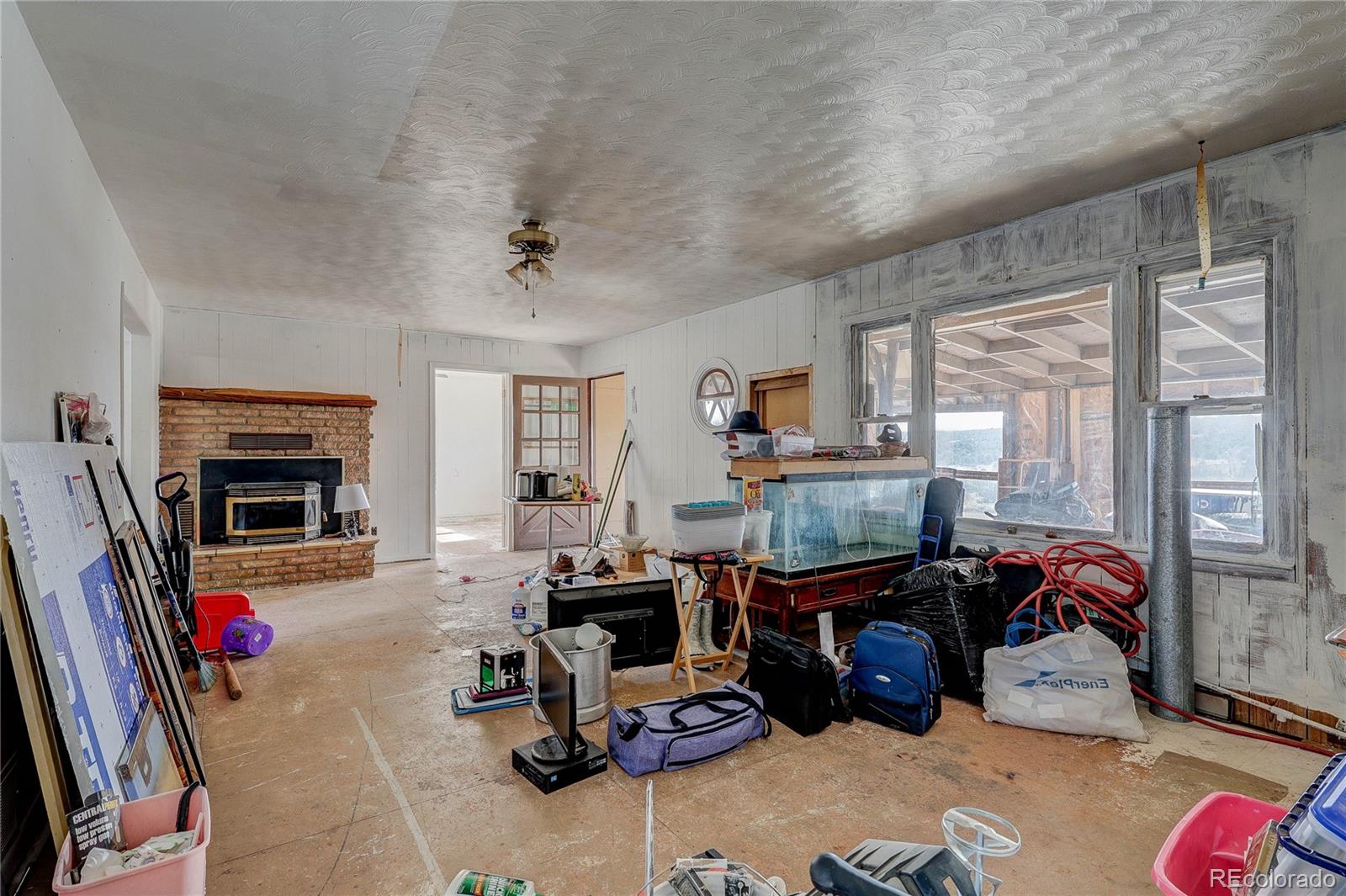 952 Twin Lakes Road Walsenburg, CO 81089 - Photo 32 of 47 a room with furniture a fireplace and gym equipment