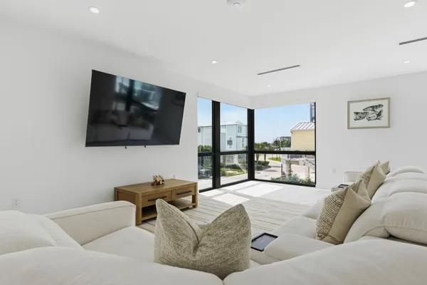 a bedroom with a large bed and a potted plant