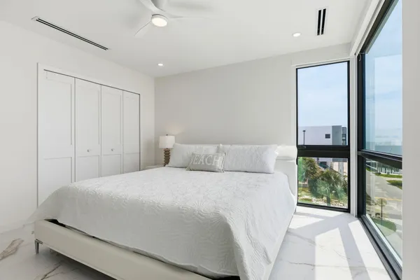 a bedroom with a bed and a window