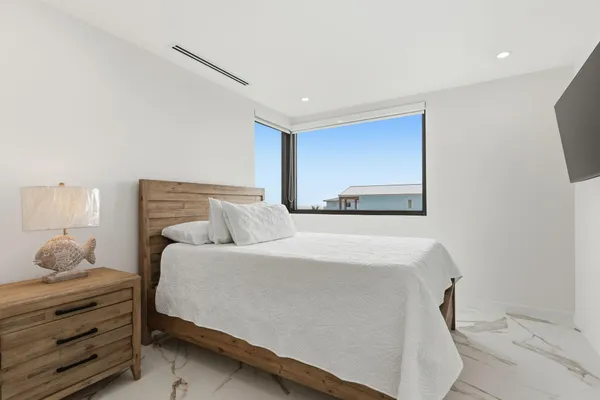 a bedroom with a bed and a lamp