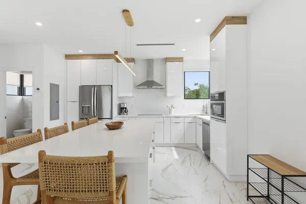 a kitchen with white cabinets and stainless steel appliances