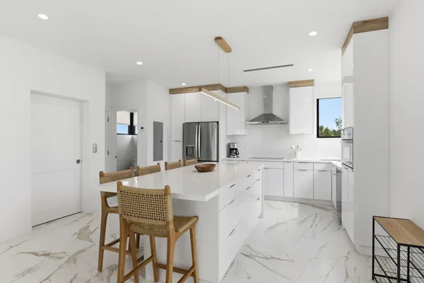 a kitchen with stainless steel appliances a stove a sink and a microwave